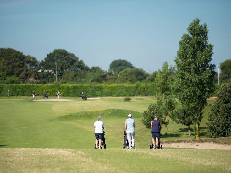 A group of retirees on a golf course in Westgate-on-Sea.