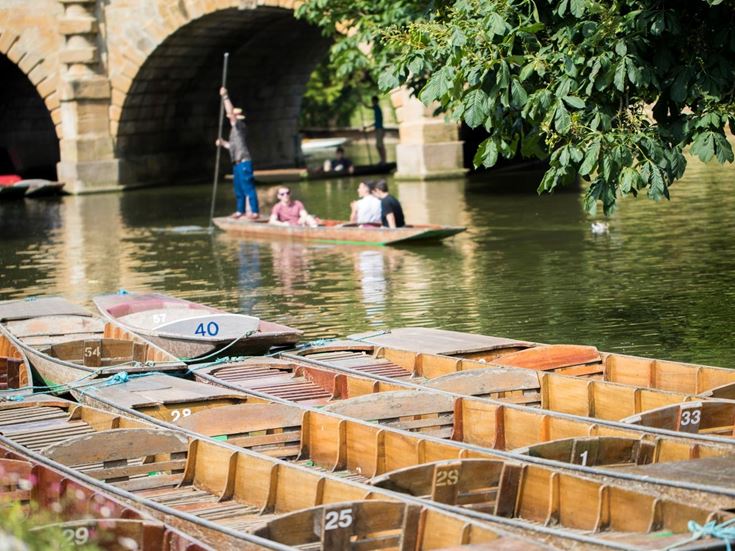 People boating in a punt on the River Cherwell in Oxford.
