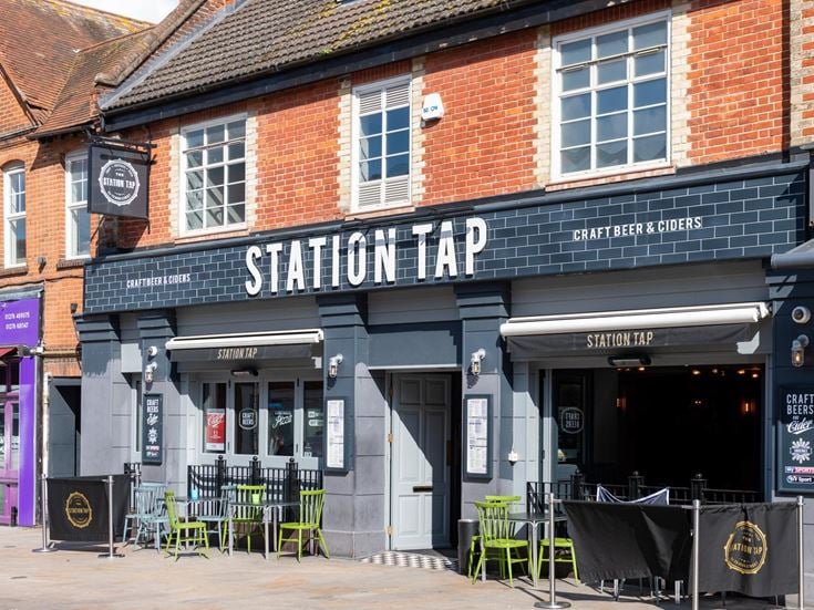 A bar in Bagshot town centre with chairs and tables in the foreground.