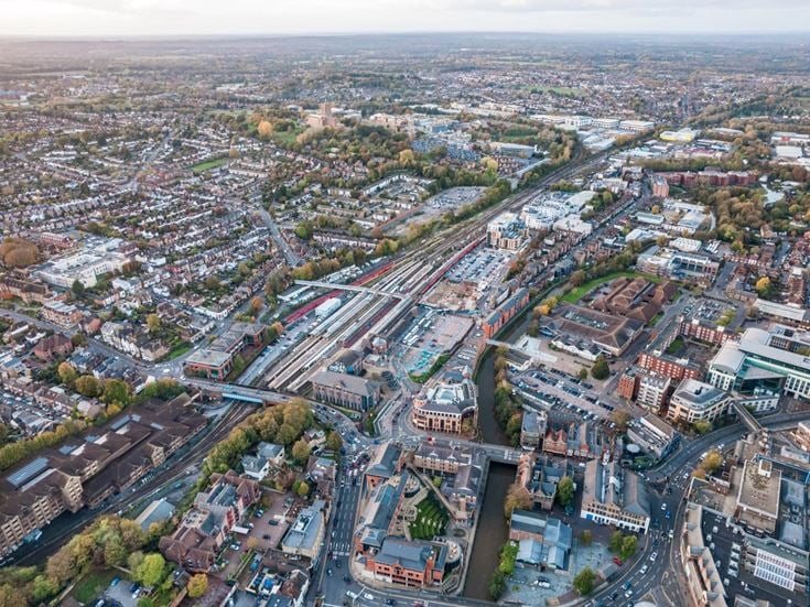 Aerial view of Guildford town centre and railway station, highlighting the town's excellent transport connections and local amenities.