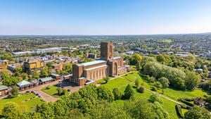 Aerial view of Guildford Cathedral overlooking Guildford town centre and the surrounding Surrey countryside.