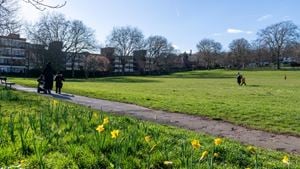 A local park close to Purley town centre with a group of people walking.