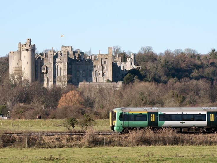 A southern railway passenger train passing Arundel Castle in West Sussex.