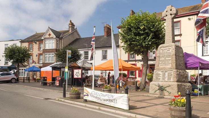 Farmers' Market stalls next to Cullompton War Memorial.