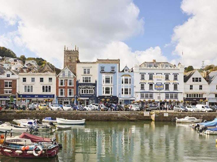 The harbour in Dartmouth with a range of shops and cafes in the background