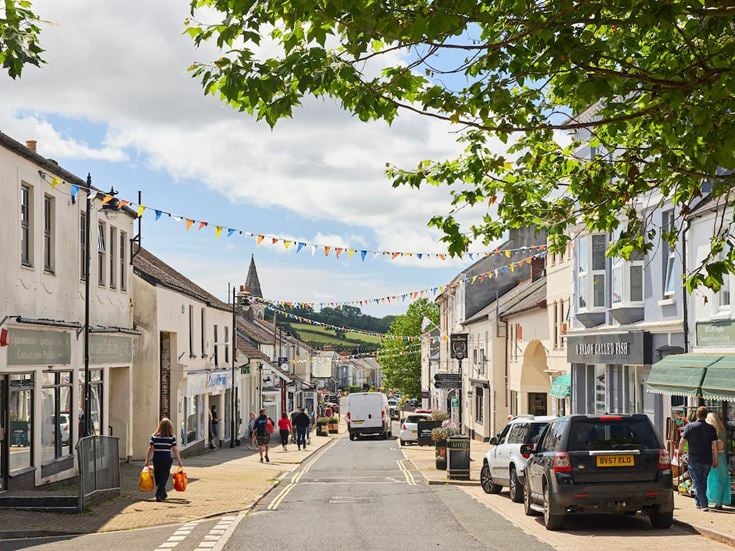 a street with cars and people on it