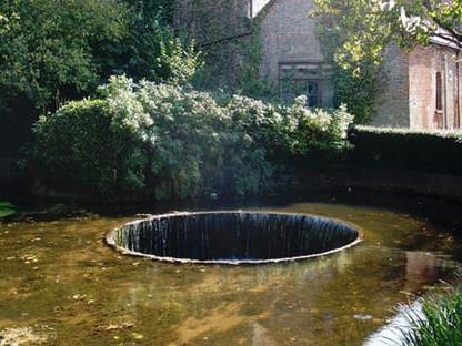 a pond with a fountain in it