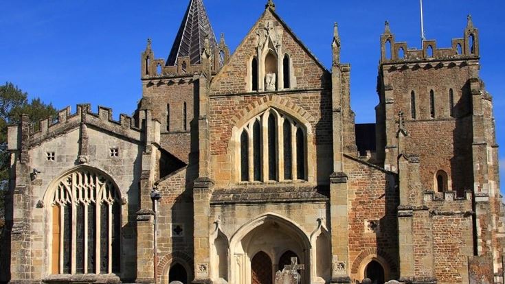a large stone church with Hereford Cathedral in the background