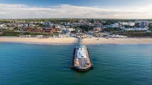 An aerial view of Bournemouth Pier from the sea with the town and beach in the background.