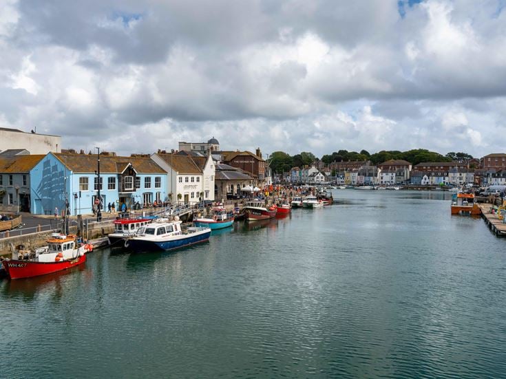 Downtown Weymouth and fishing boats on the River Wey in Dorchester