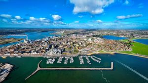 Aerial view of historic Poole Quay and Poole Park, showcasing Poole's waterfront and green spaces.