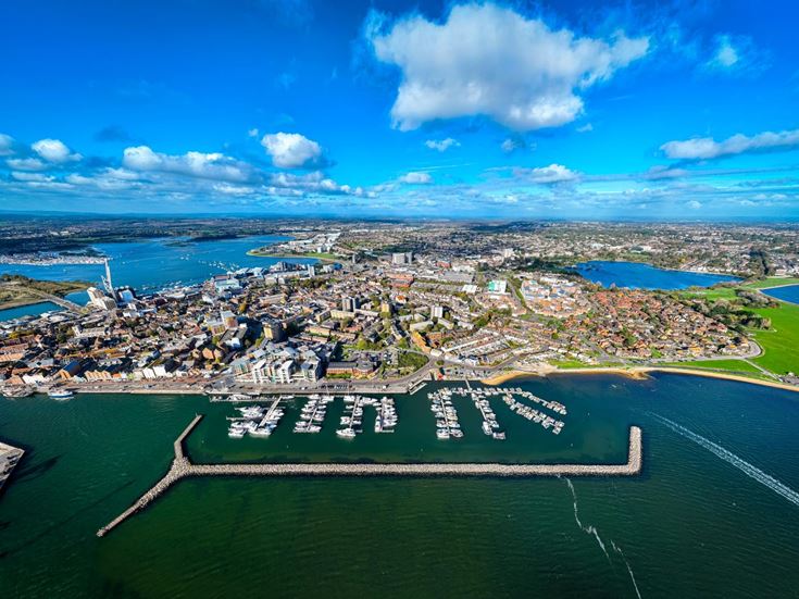 Aerial view of historic Poole Quay and Poole Park, showcasing Poole's waterfront and green spaces.
