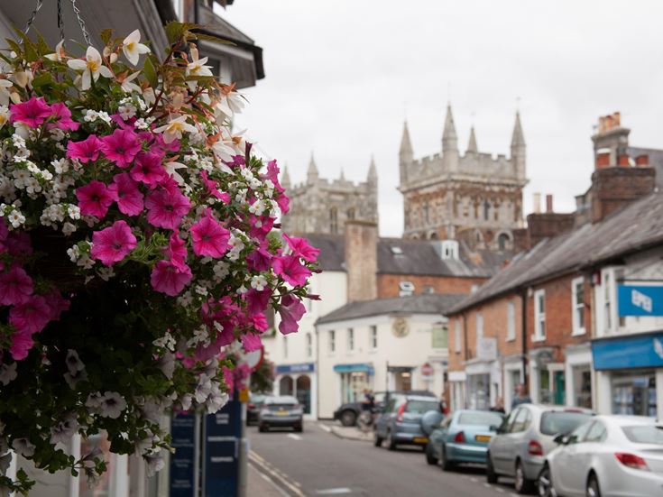 Views of East Street and the Minster Church of St Cuthburga in Wimborne, Dorset in the UK