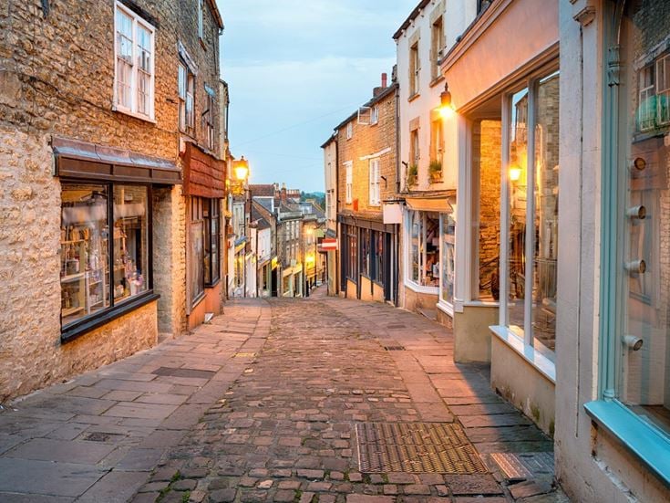 a cobblestone street with buildings on both sides