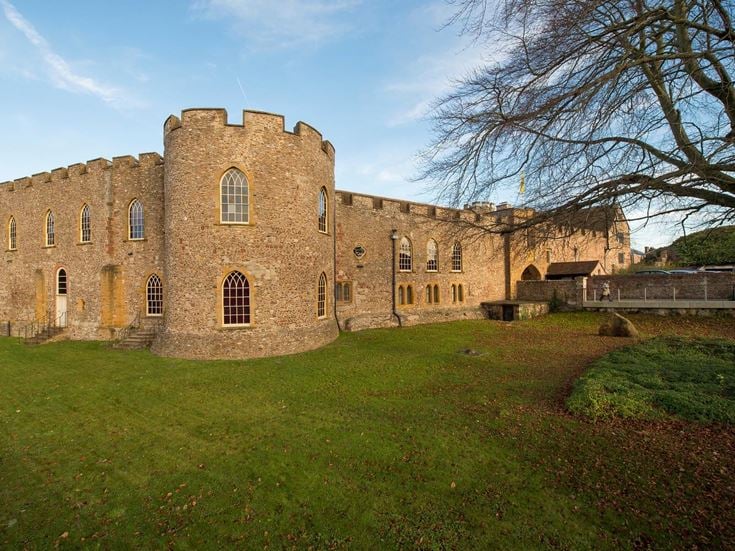The exterior view of Taunton Castle on a sunny day.