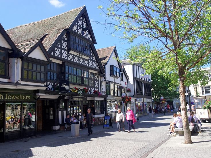 A Tudor building in Taunton town centre, with people walking by.