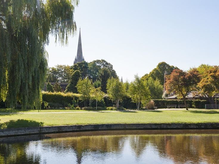 The River Avon running through Queen Elizabeth Gardens, with Salisbury Cathedral in the background.