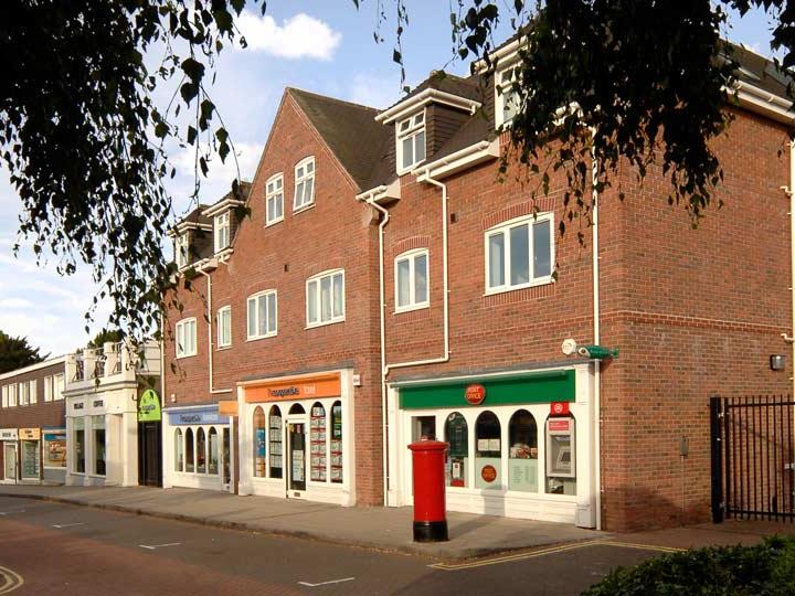 a brick building with a red post