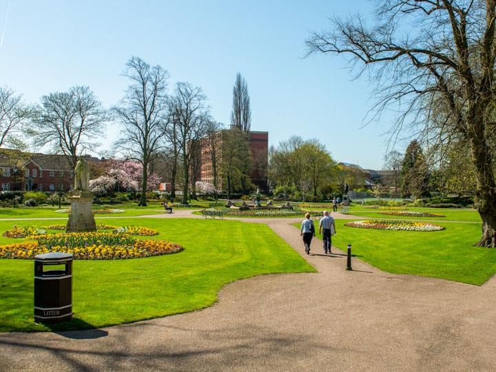Retirees walking through a Beacon Park in Lichfield.