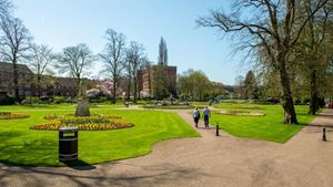 Retirees walking through a Beacon Park in Lichfield.