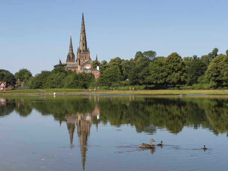 A view of the front of Lichfield Cathedral on a sunny day.