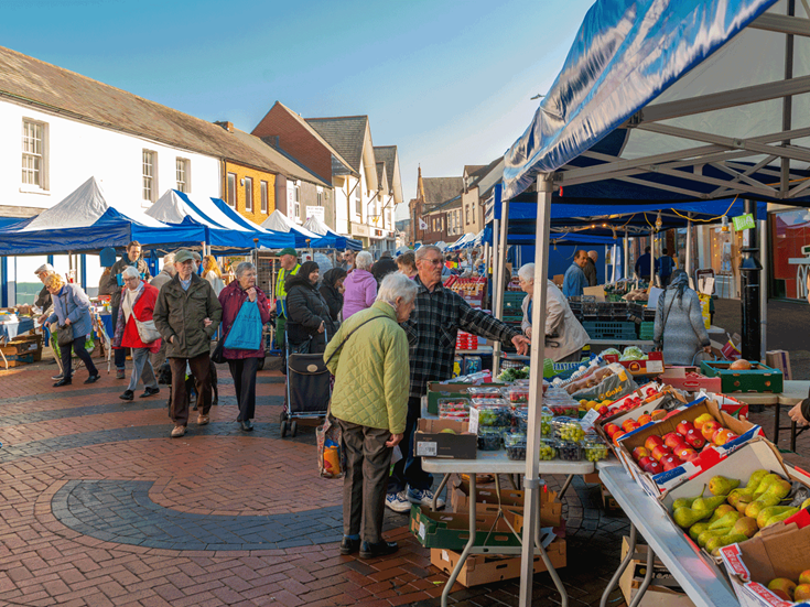 a group of people at a farmers market