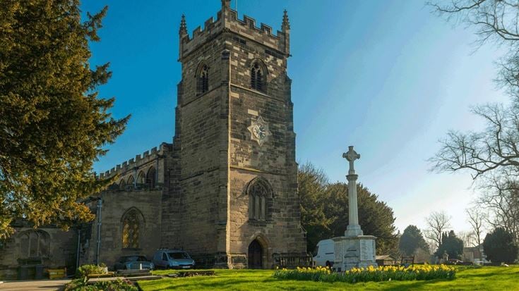 a stone church with a cross on top
