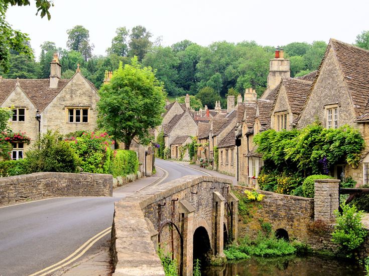 Old houses in Castle Combe, England - a view of the Cotswolds over a river