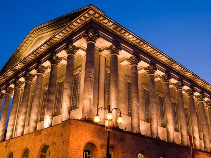 An exterior view of Birmingham Town Hall at dusk.