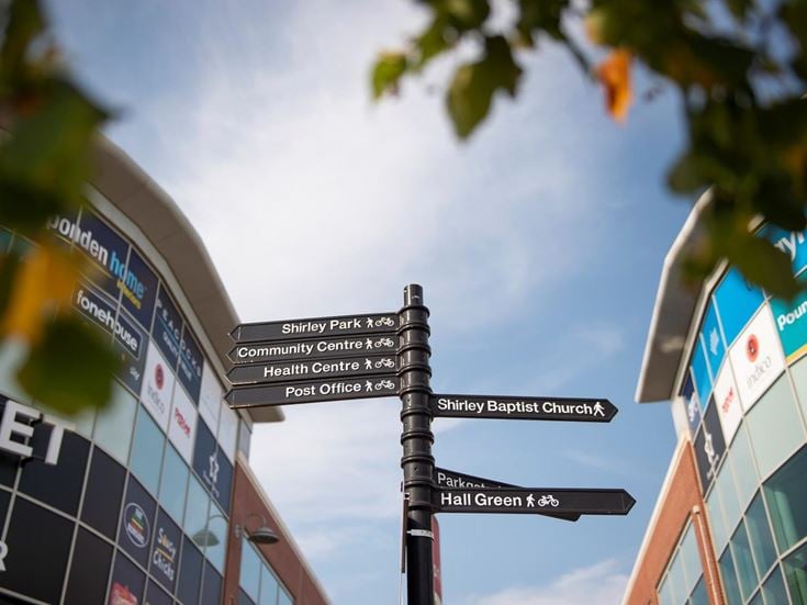 Signpost providing directions to various amenities in Shirley.