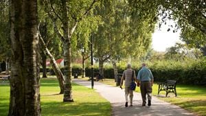 Two retired men enjoy a leisurely stroll through a park in Shirley.