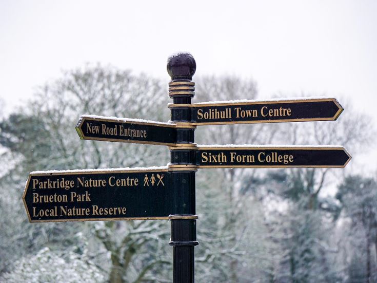 A street signpost with directing to several local attractions in Solihull.