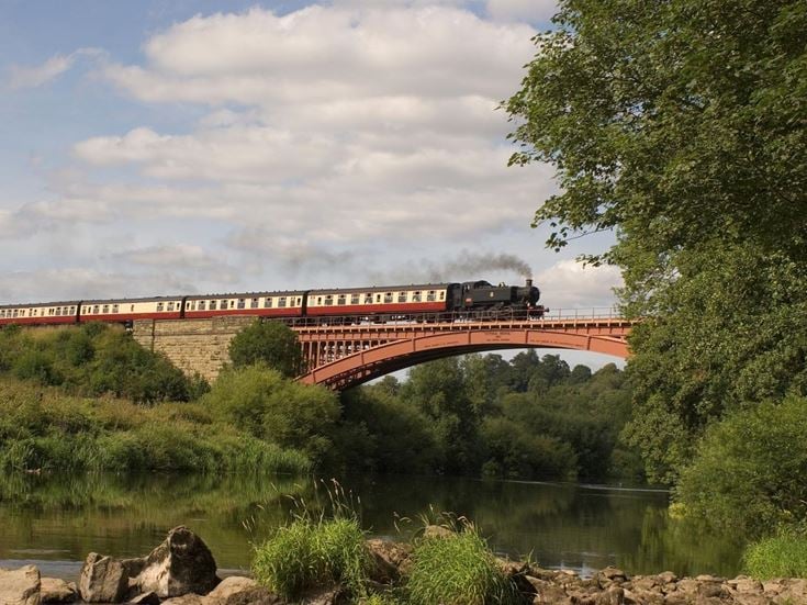 A steam train crossing the Victoria Bridge over the River Severn in Worcestershire.