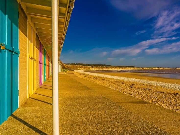 A row of colourful beach huts along North Beach, Bridlington.