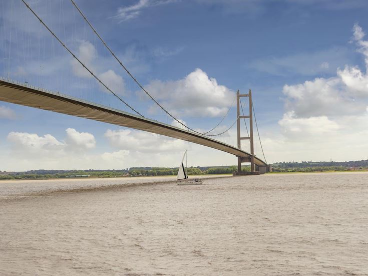 A boat travels under Humber Bridge near Kingston upon Hull.