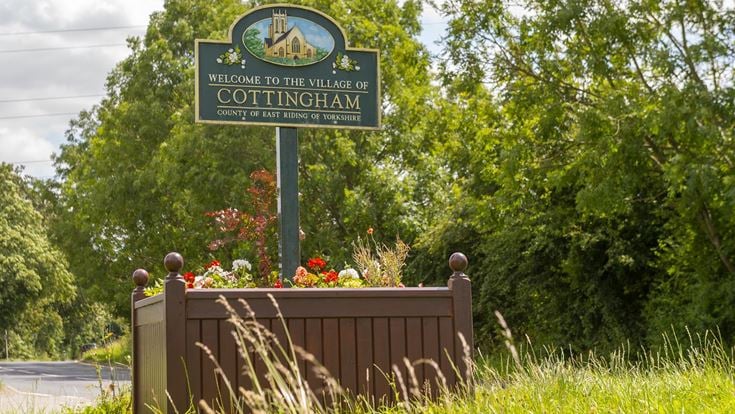 Road sign welcoming drivers to the village of Cottingham.