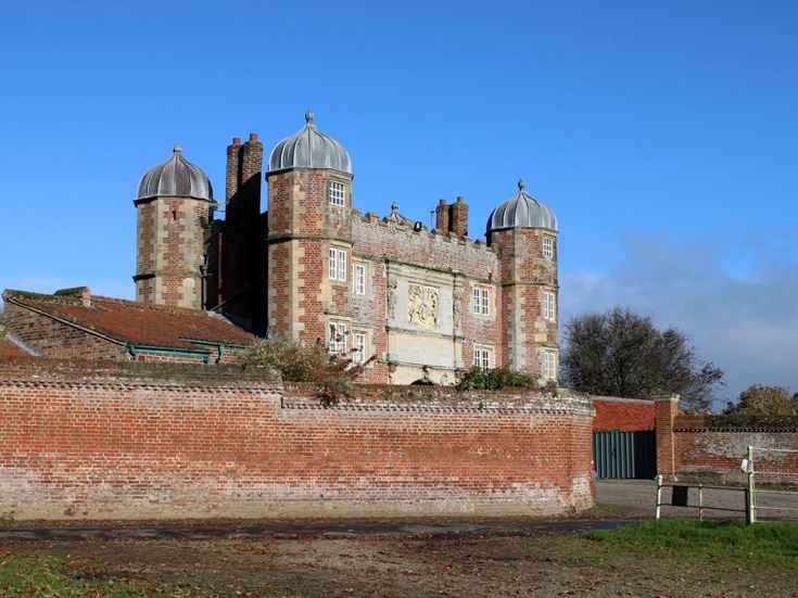 Burton Agnes Hall in East Yorkshire, with red brick towers and metal domes.