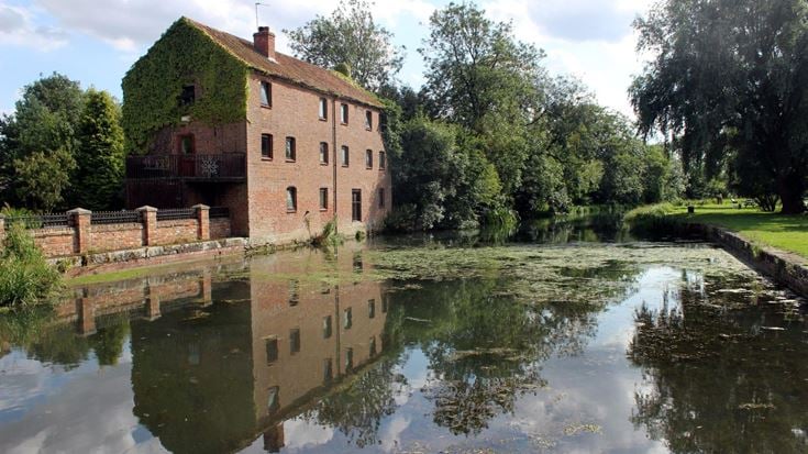a brick building next to canal
