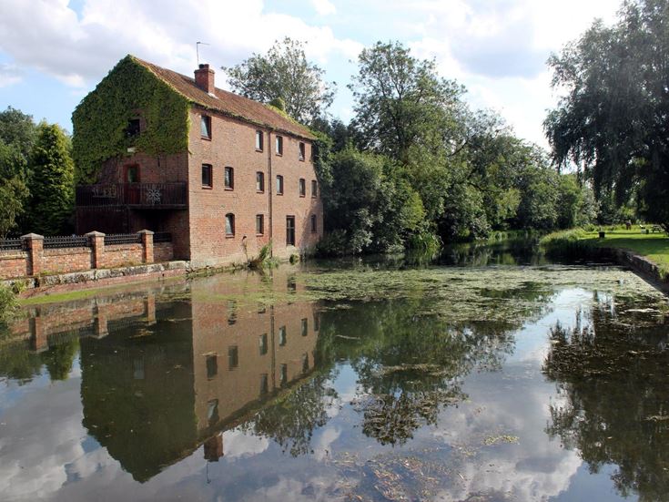 a brick building next to canal