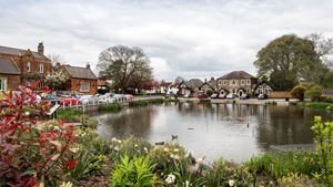 a pond with plants and buildings around it