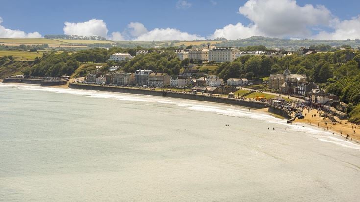 An aerial view of Filey town and beach on a sunny day.