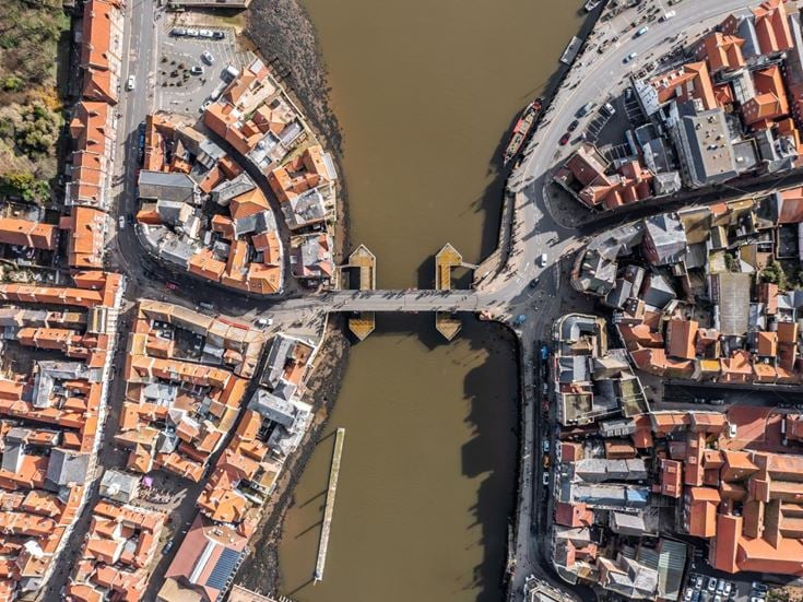 Aerial view of Whitby, showing both sides of town and the central swing bridge