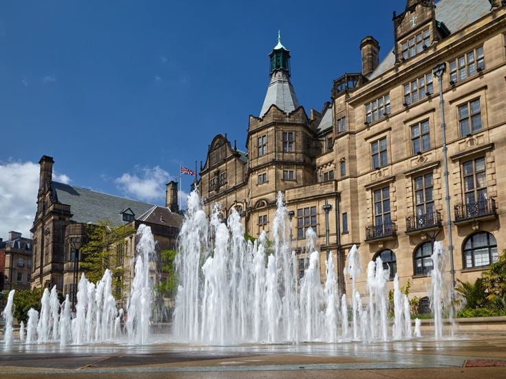 The fountains in front of a building in the Sheffield Peace Gardens.