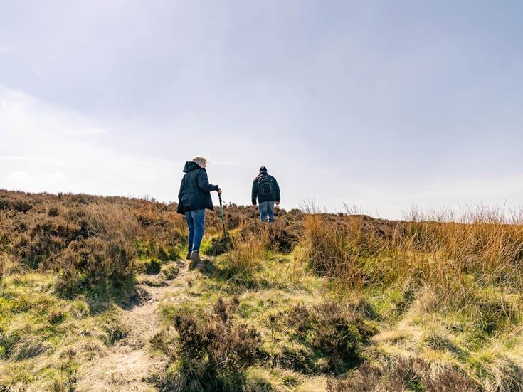 Two retirees hiking over the Yorkshire Moors in Burley in Wharfedale