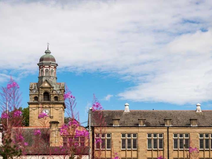 a building with a dome and a tower with a clock on it