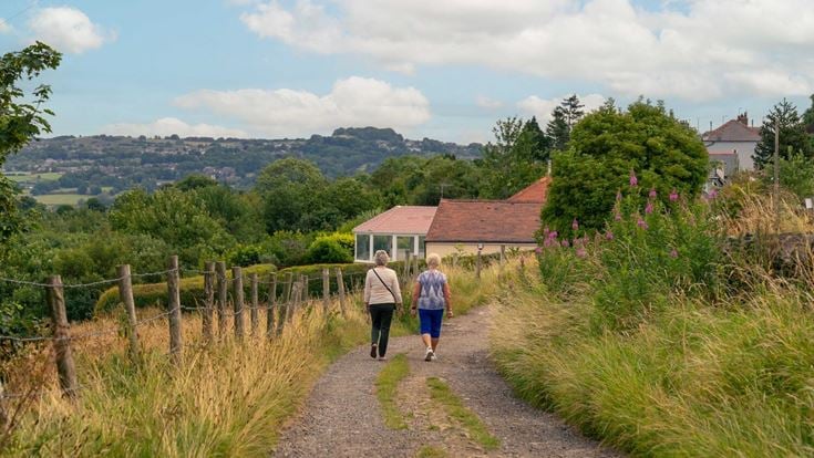Two retirees walking along a path on the outskirts of the suburb of Idle, Bradford.