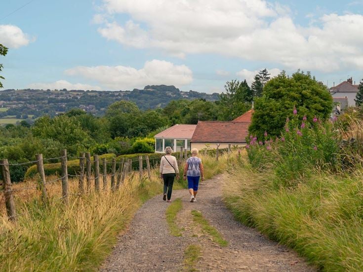 Two retirees walking along a path on the outskirts of the suburb of Idle, Bradford.