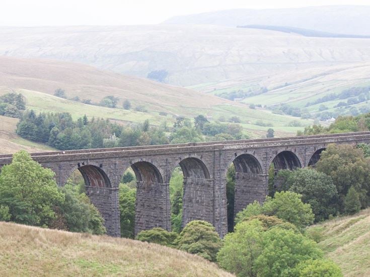 A viaduct looming over the countryside outside of Leeds