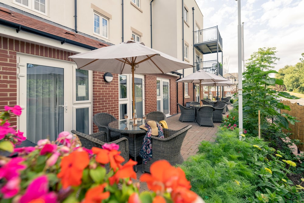 a patio with chairs and tables and umbrellas