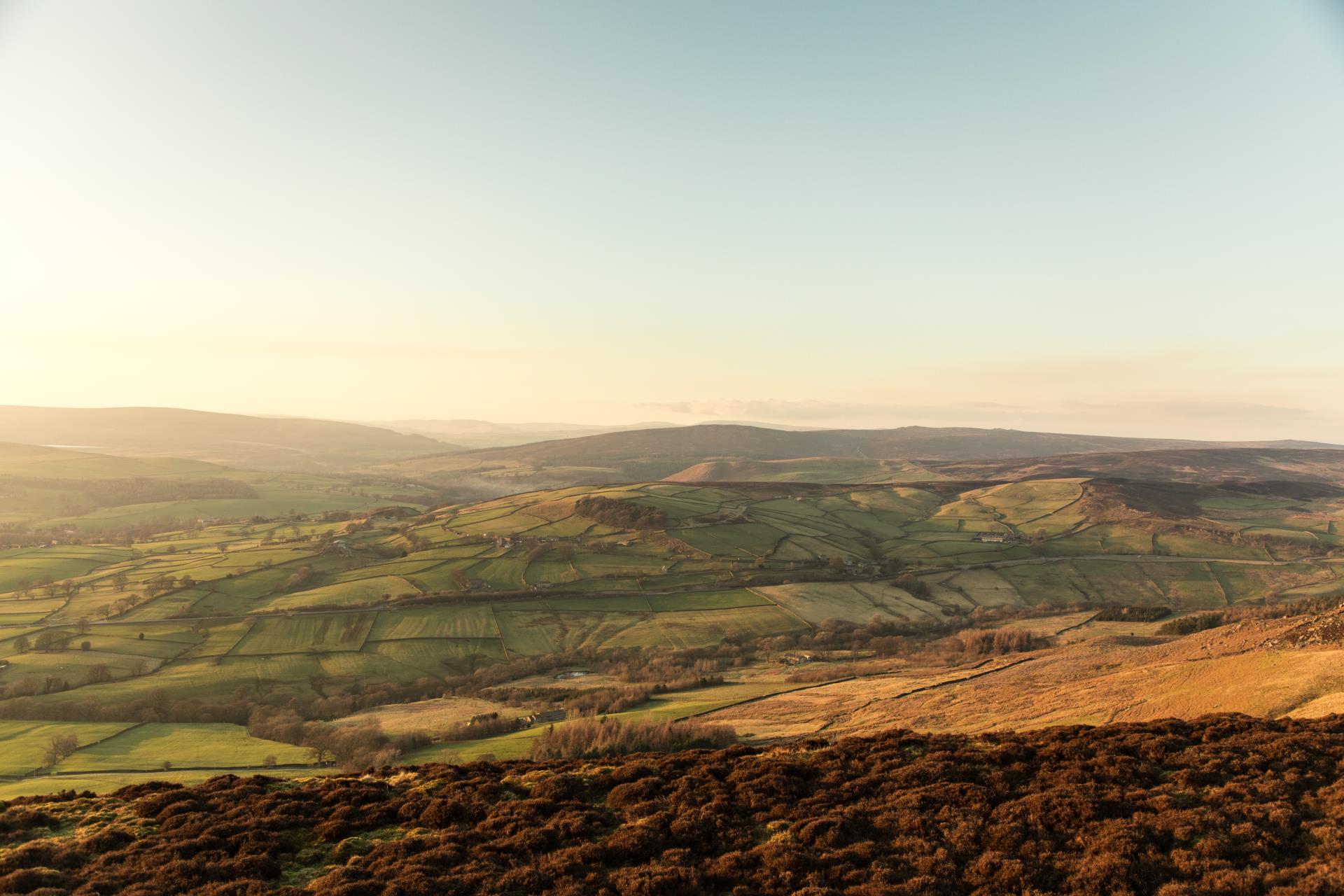 a landscape with hills and a blue sky